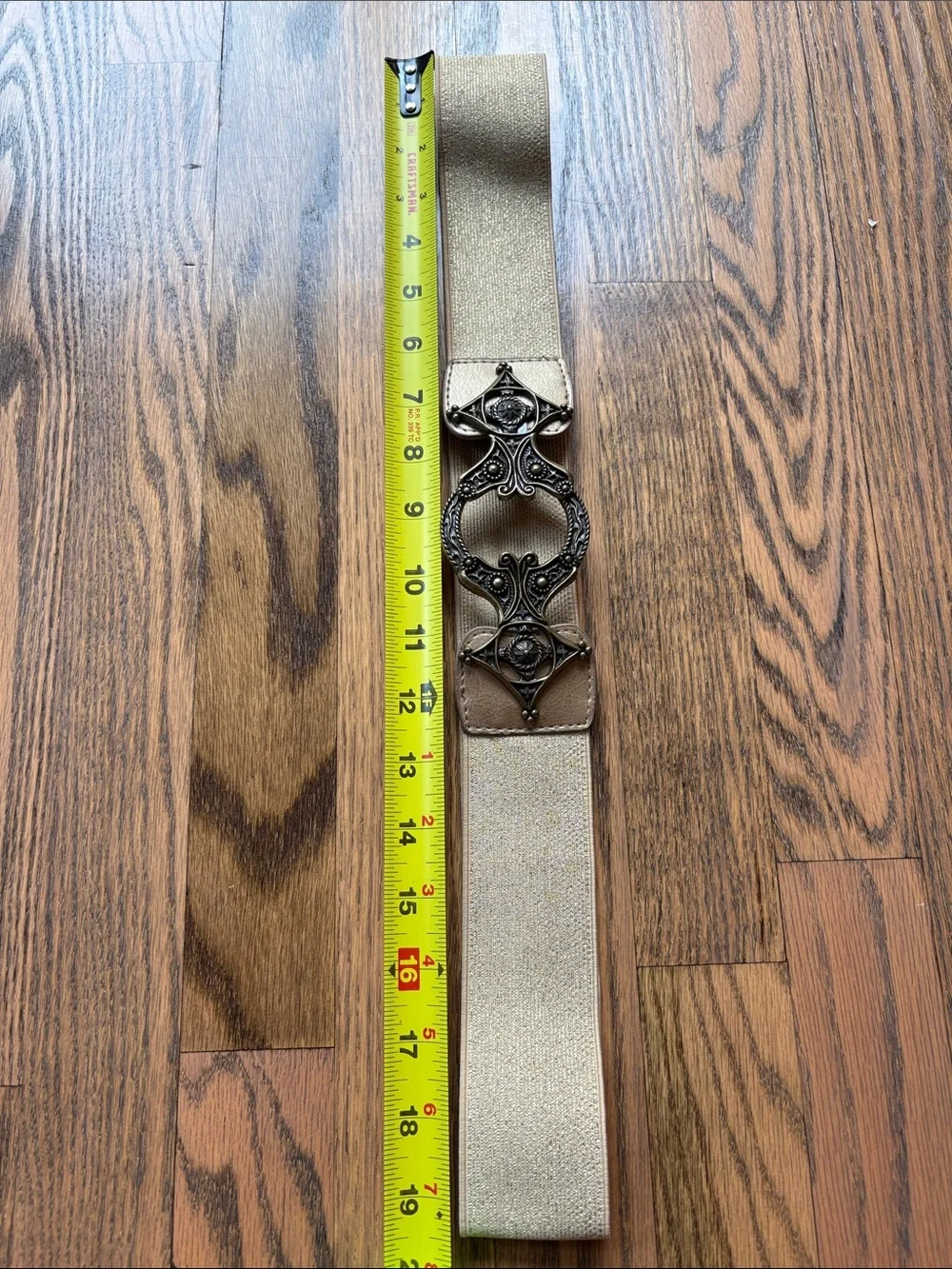 Metallic gold stretchy belt with ornate brass look buckle